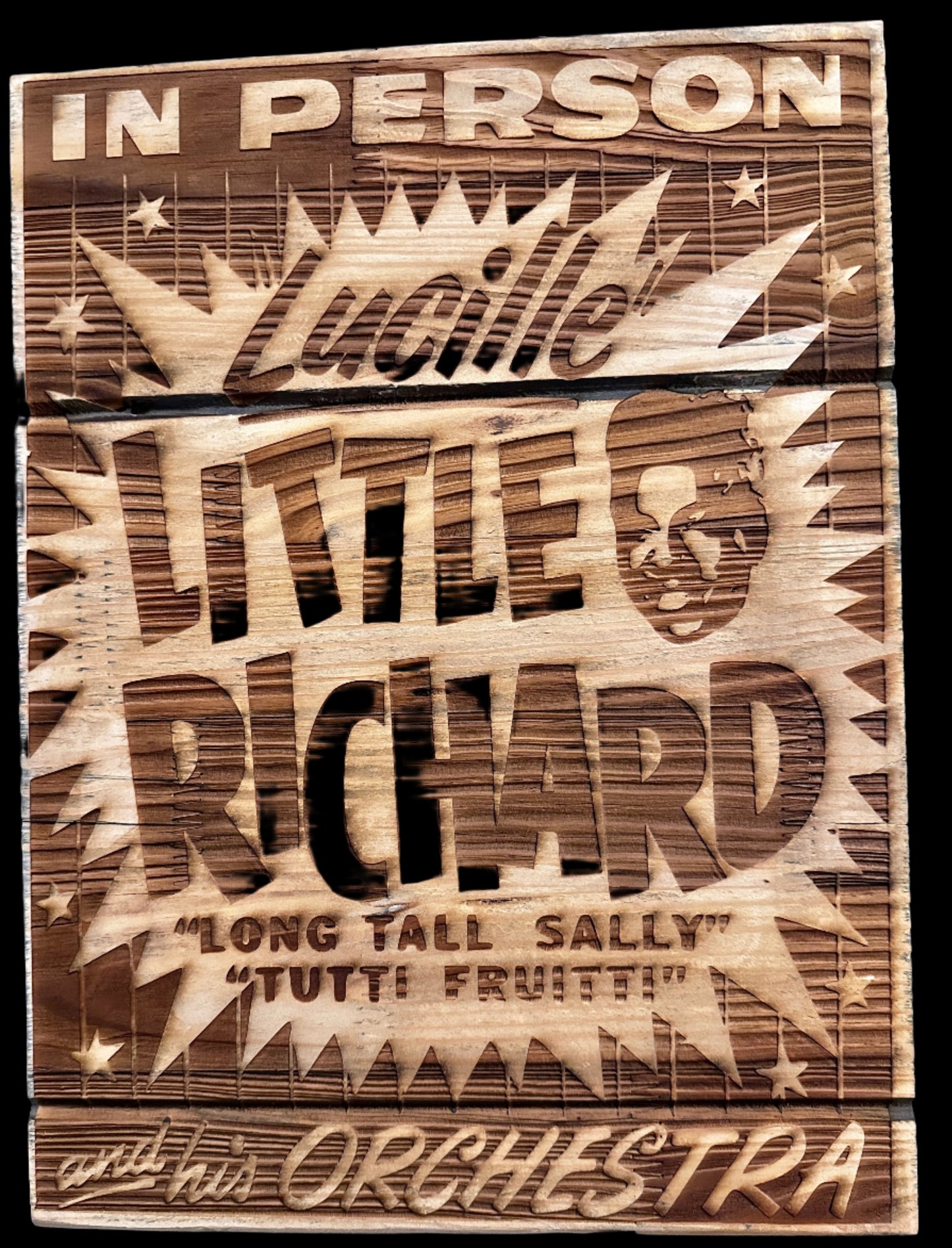 Sign reading "In Person, Lucille, Little Richard, Long Tall Sally, Tutti Fruiti, and his Orchestra" on wood.