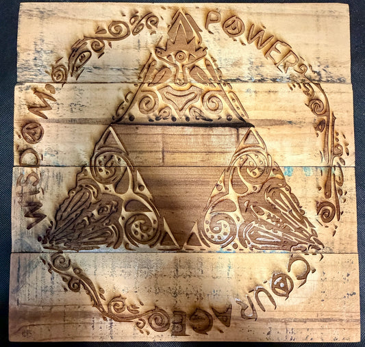 Wooden block with engraved design and text on a dark surface
