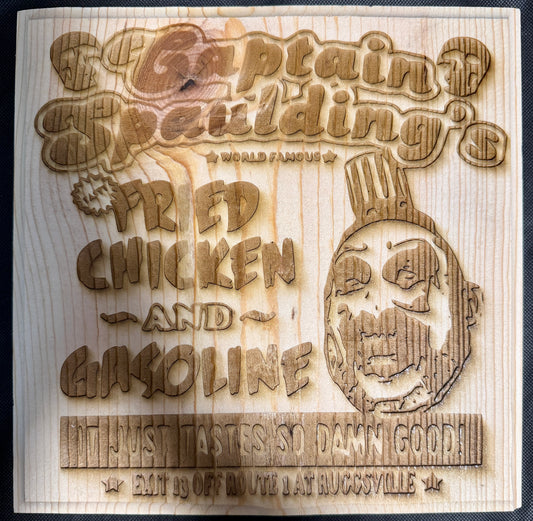 Wooden sign with laser-cut text and skull design, featuring 'Captain Spaulding's' and 'Fried Chicken and Gasoline'.