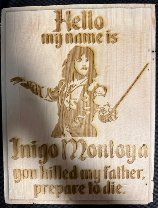 Wooden plaque with engraved text and illustration of a character, resembling a scene from a movie or book.